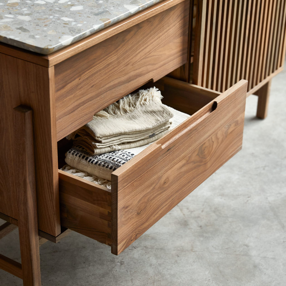 Tikamoon Isaure walnut sideboard, top-down view of the stone top