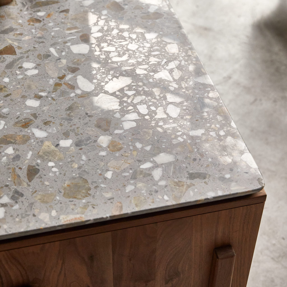 Tikamoon Isaure walnut sideboard, close-up of the terrazzo top surface