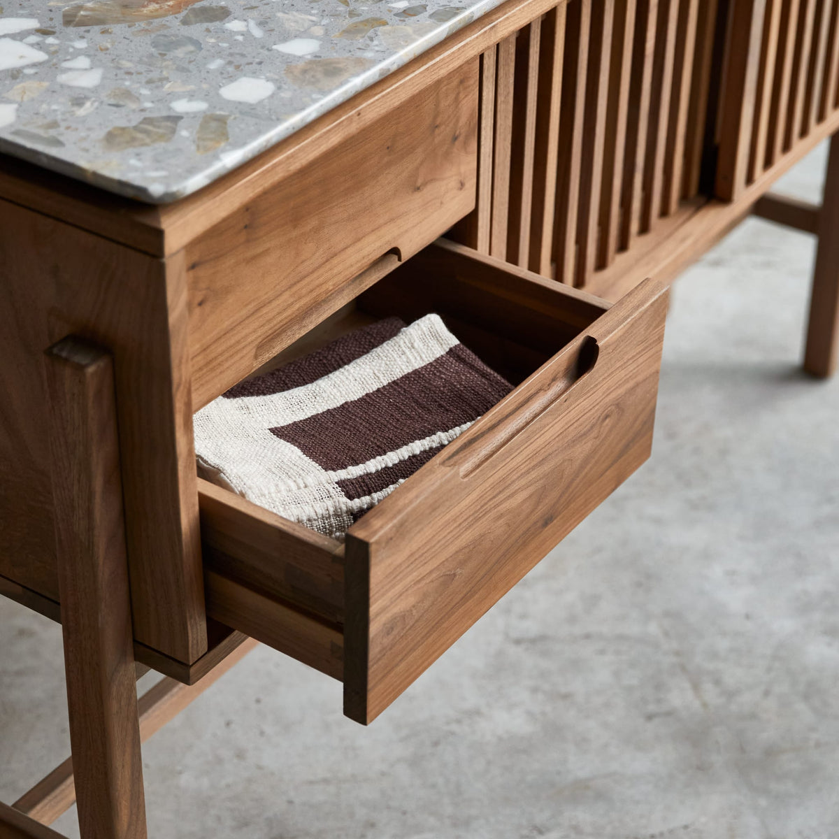 Tikamoon Isaure console table in solid walnut and terrazzo, detail of a drawer front
