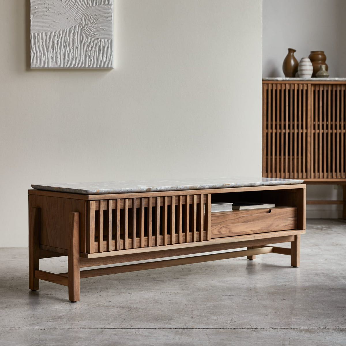 Tikamoon Isaure TV stand in solid walnut with a terrazzo top, side view