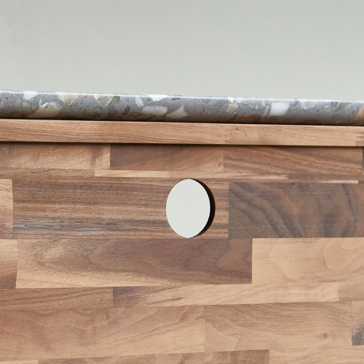 Tikamoon Isaure TV stand in solid walnut with a terrazzo top, detail of the base