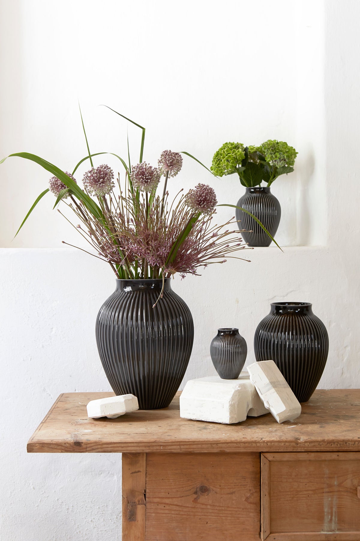 Knabstrup Ripple Vase in black, styled in an interior setting, glazed earthenware