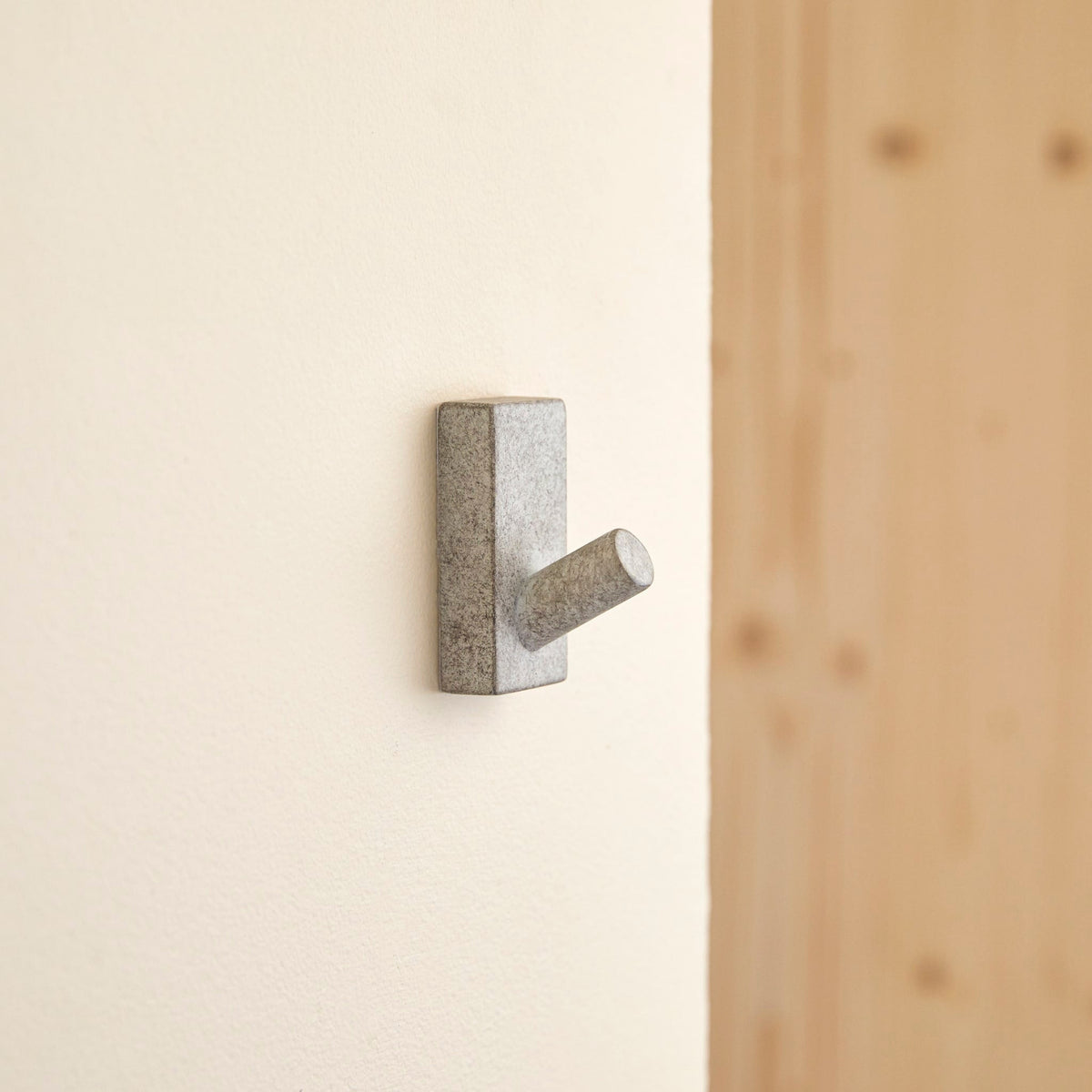 Tikamoon Sara coat hook in grey concrete, front view