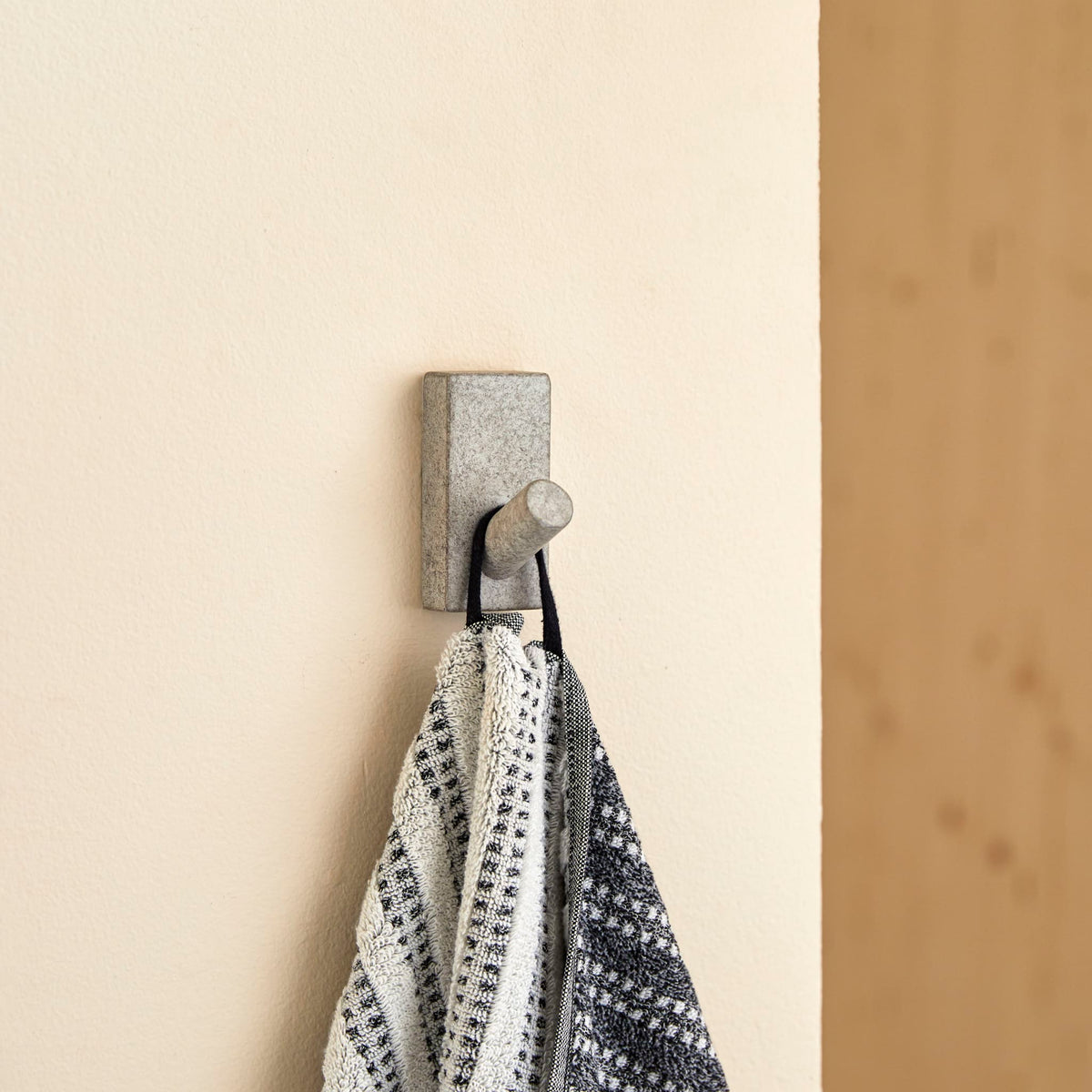 Tikamoon Sara grey concrete coat hook, side view showing the projection