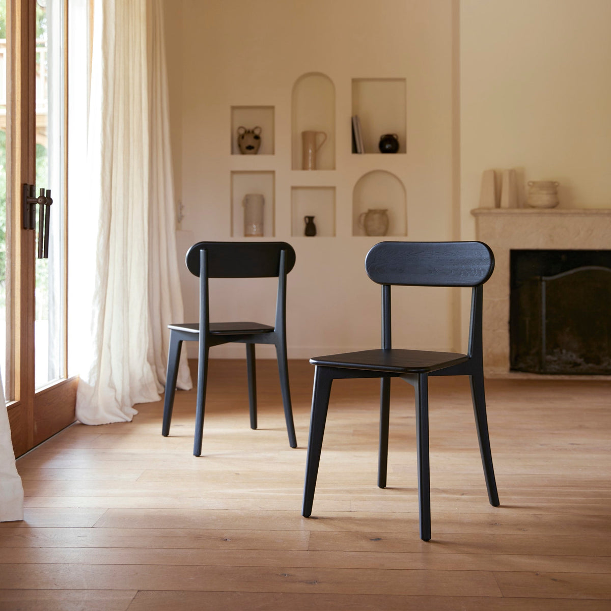 Tikamoon Abel black solid oak dining chair, angled view