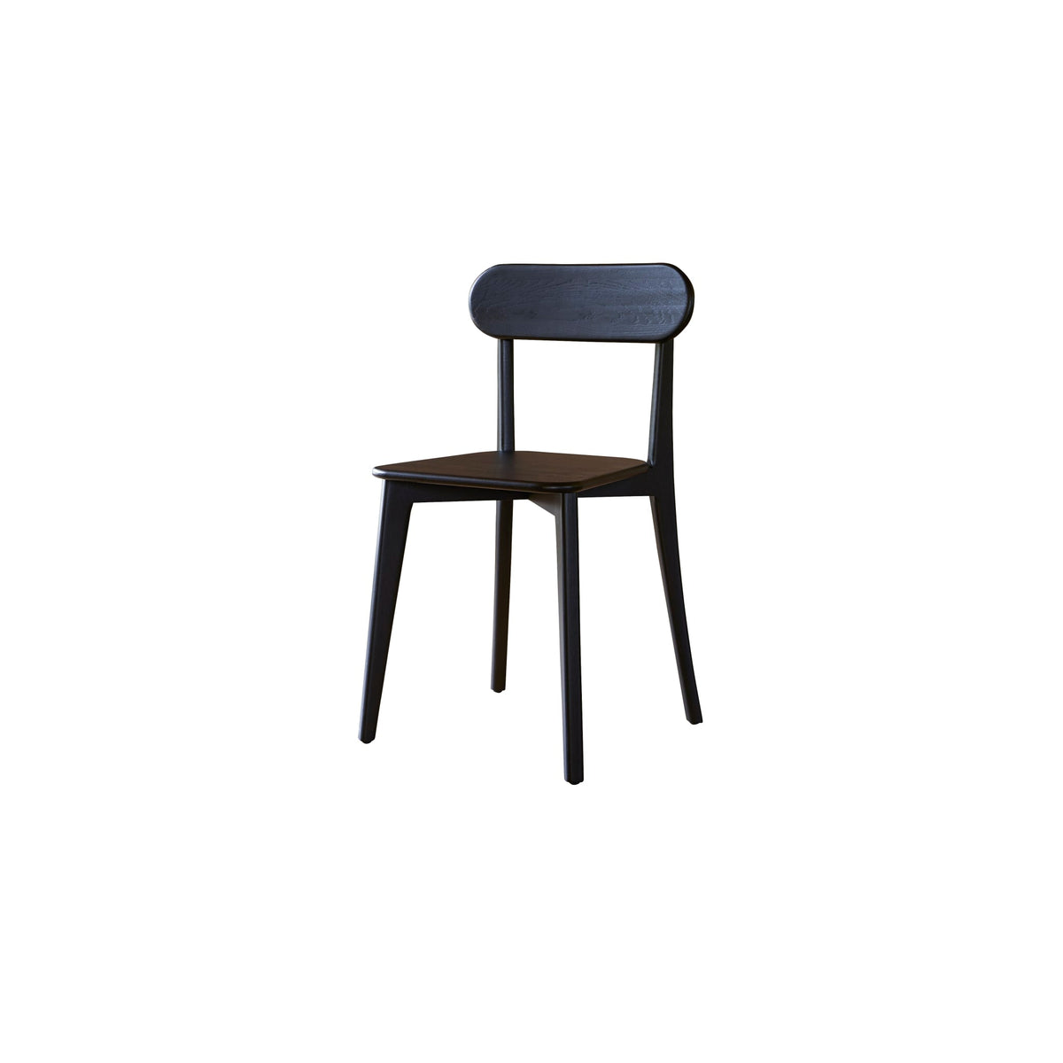 Tikamoon Abel black oak dining chairs around a table in a styled room