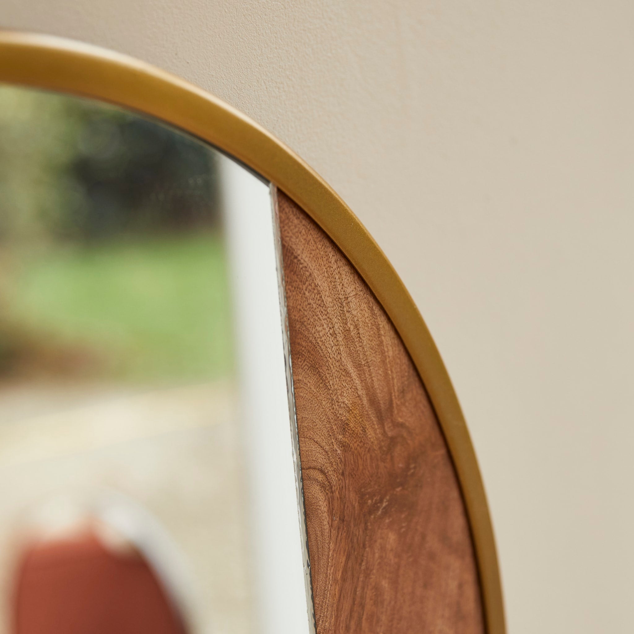 Andrea gold metal and wood mirror, angled detail view