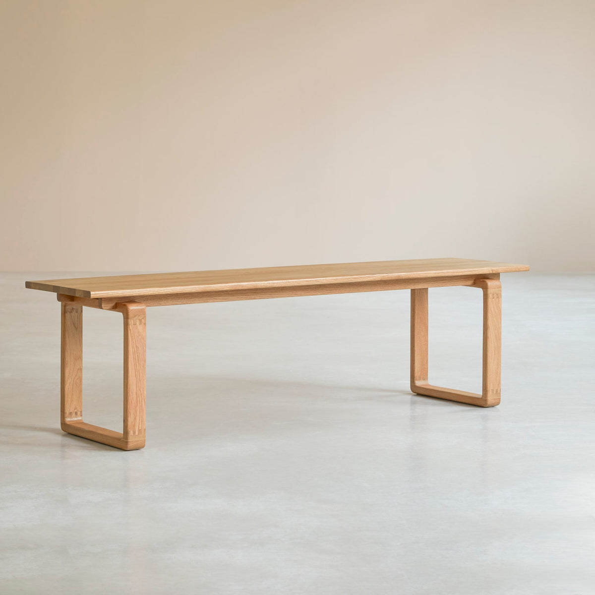 Tikamoon Sybille solid oak bench, three-quarter view in a plain setting