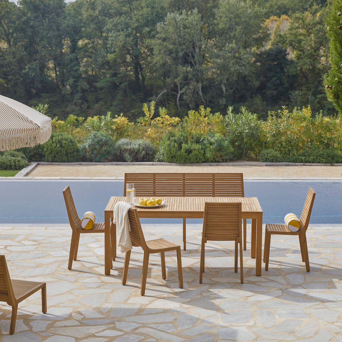 Tikamoon Téo outdoor dining set in solid teak, angled view of table, bench and chairs