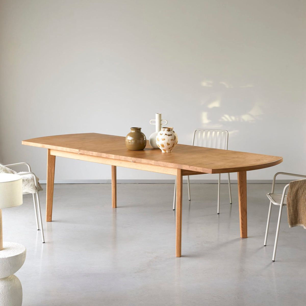 Tikamoon Maia extendable dining table in solid oak, angled view