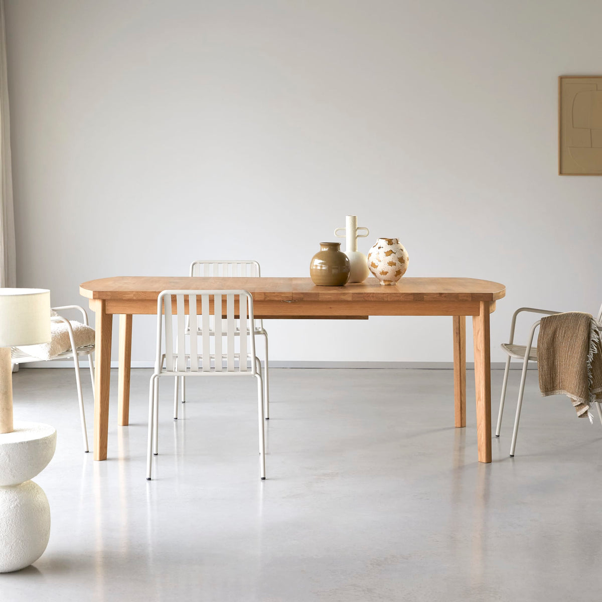 Tikamoon Maia extendable oak dining table, three-quarter view