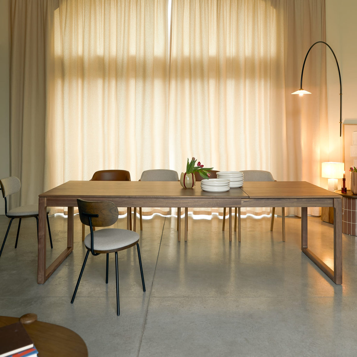 Tikamoon Arto extendable dining table in solid walnut, angled view