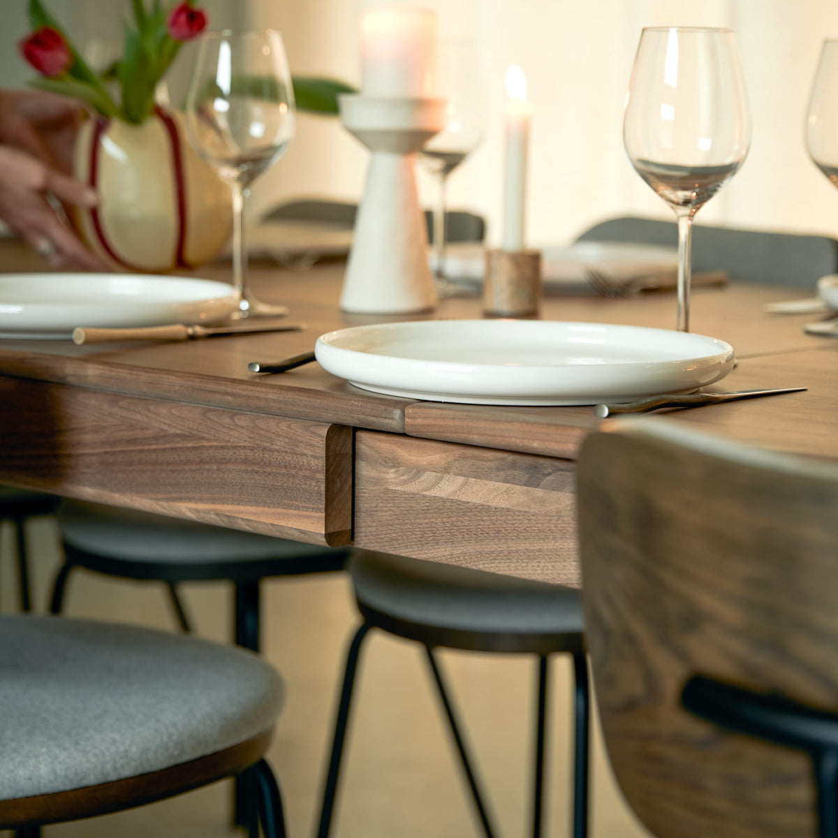 Tikamoon Arto extendable dining table in solid walnut, front view along the long edge
