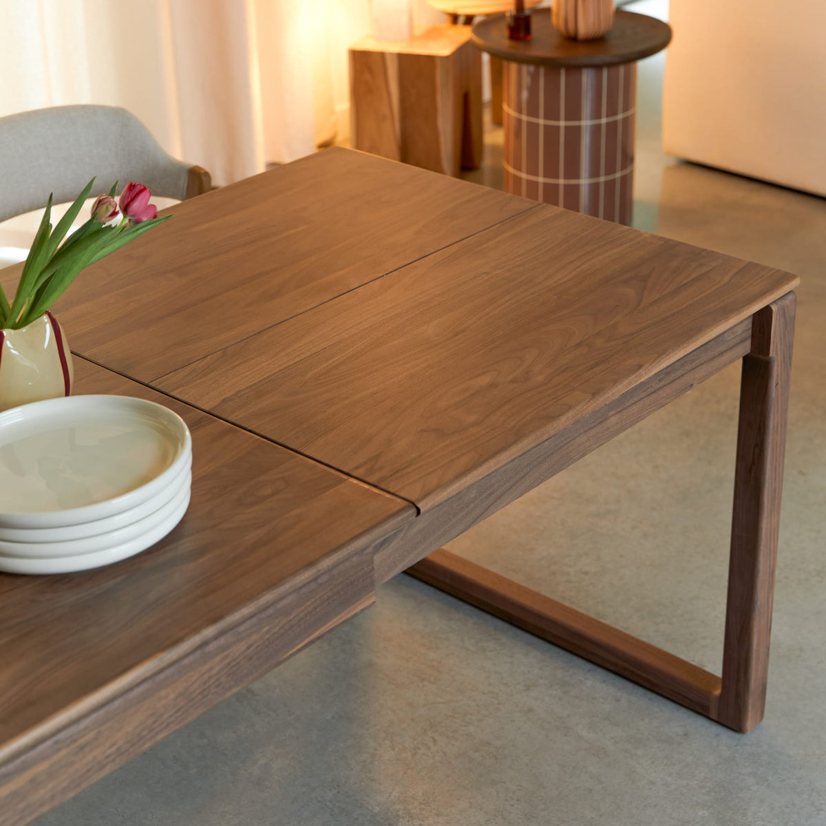 Tikamoon Arto extendable dining table in solid walnut, three-quarter view from one corner