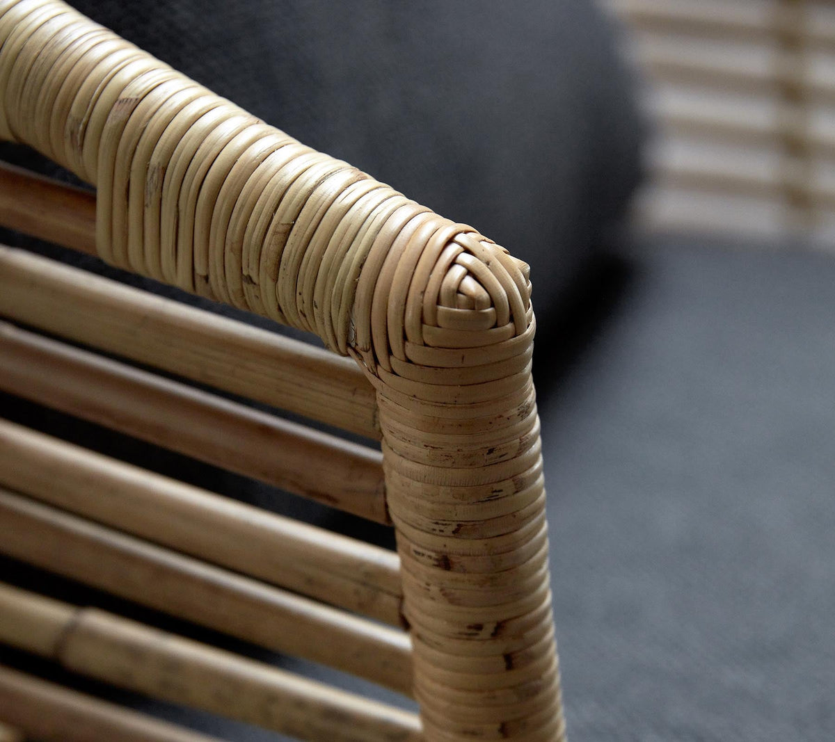 Detail of Cane-line Sense Lounge Chair armrest in handmade natural rattan