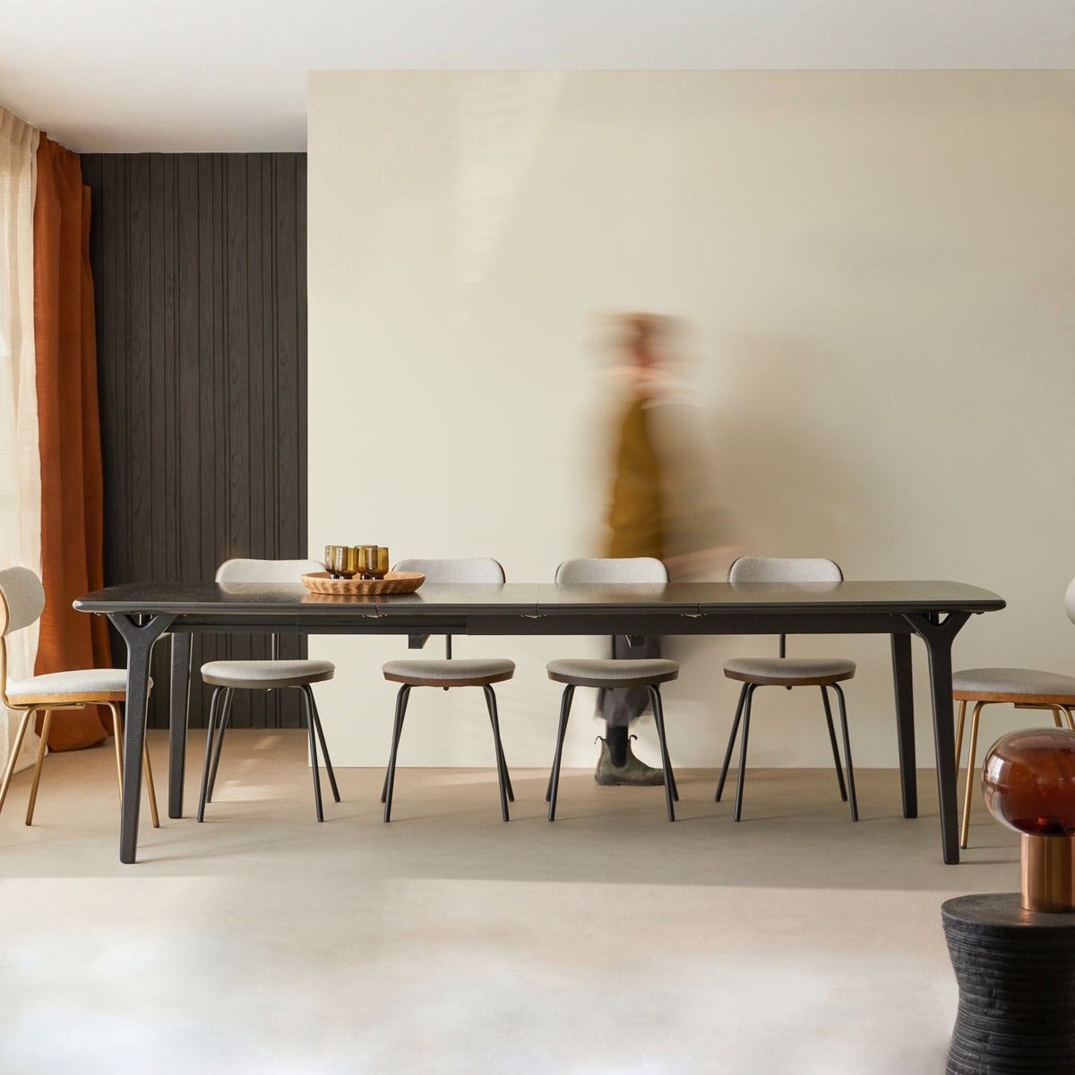Tikamoon Clara black oak dining table fully extended and set with chairs
