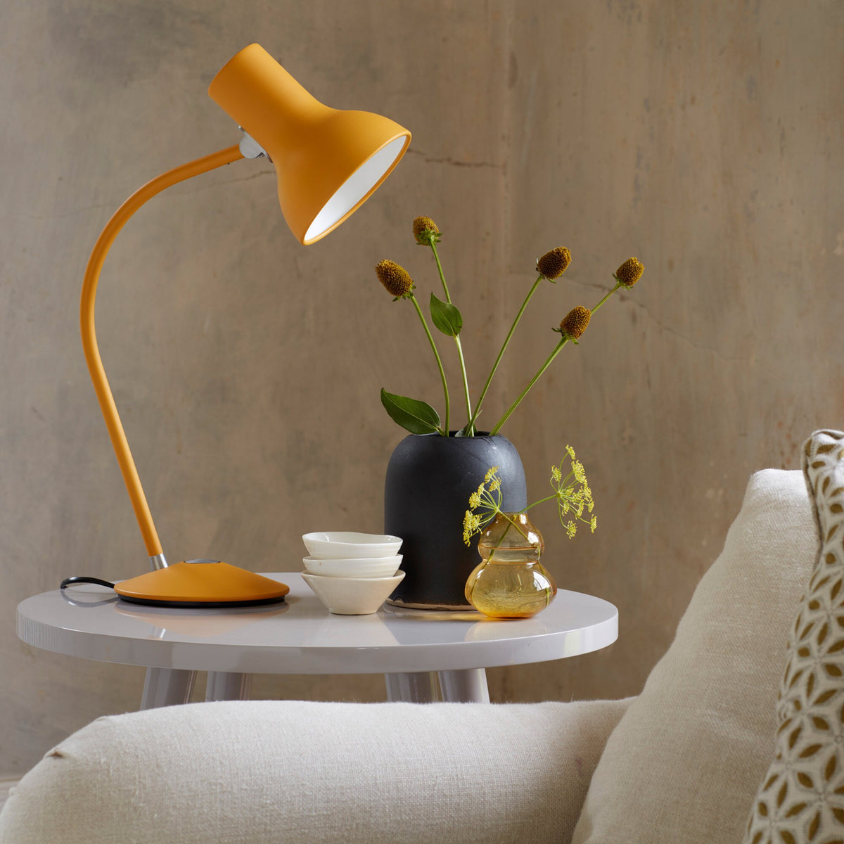 Anglepoise Type 75 Mini table lamp in Turmeric Gold on a round white side table