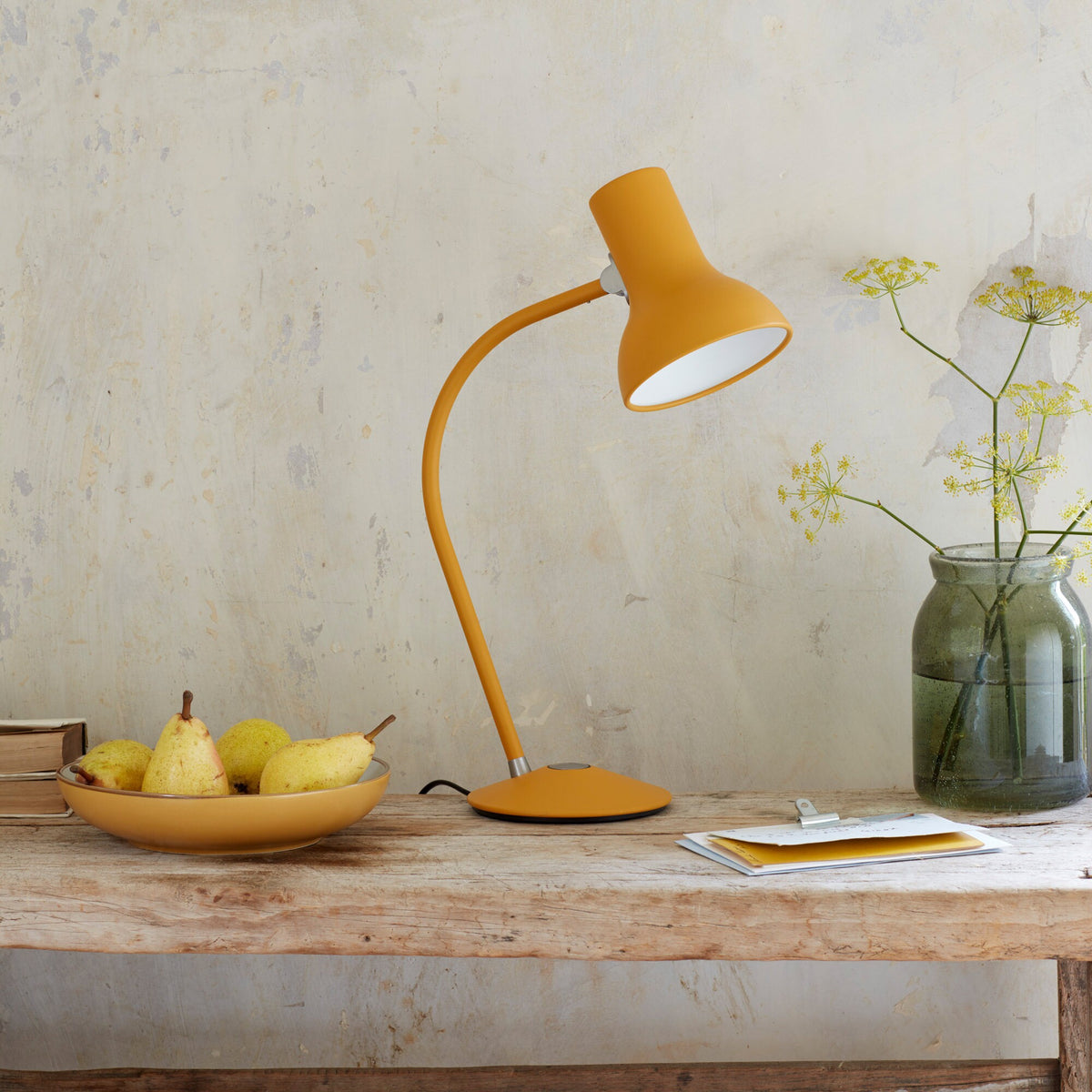 Anglepoise Type 75 Mini table lamp in Turmeric Gold on a wooden table with a bowl of fruit