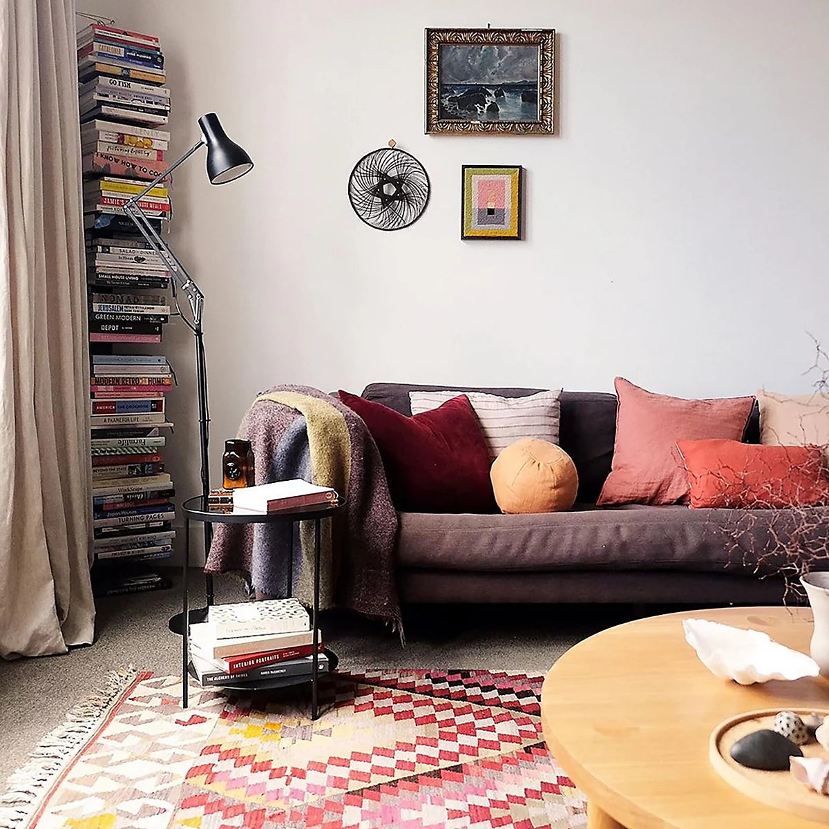 Anglepoise Type 75 floor lamp in black next to a sofa in a colorful living room