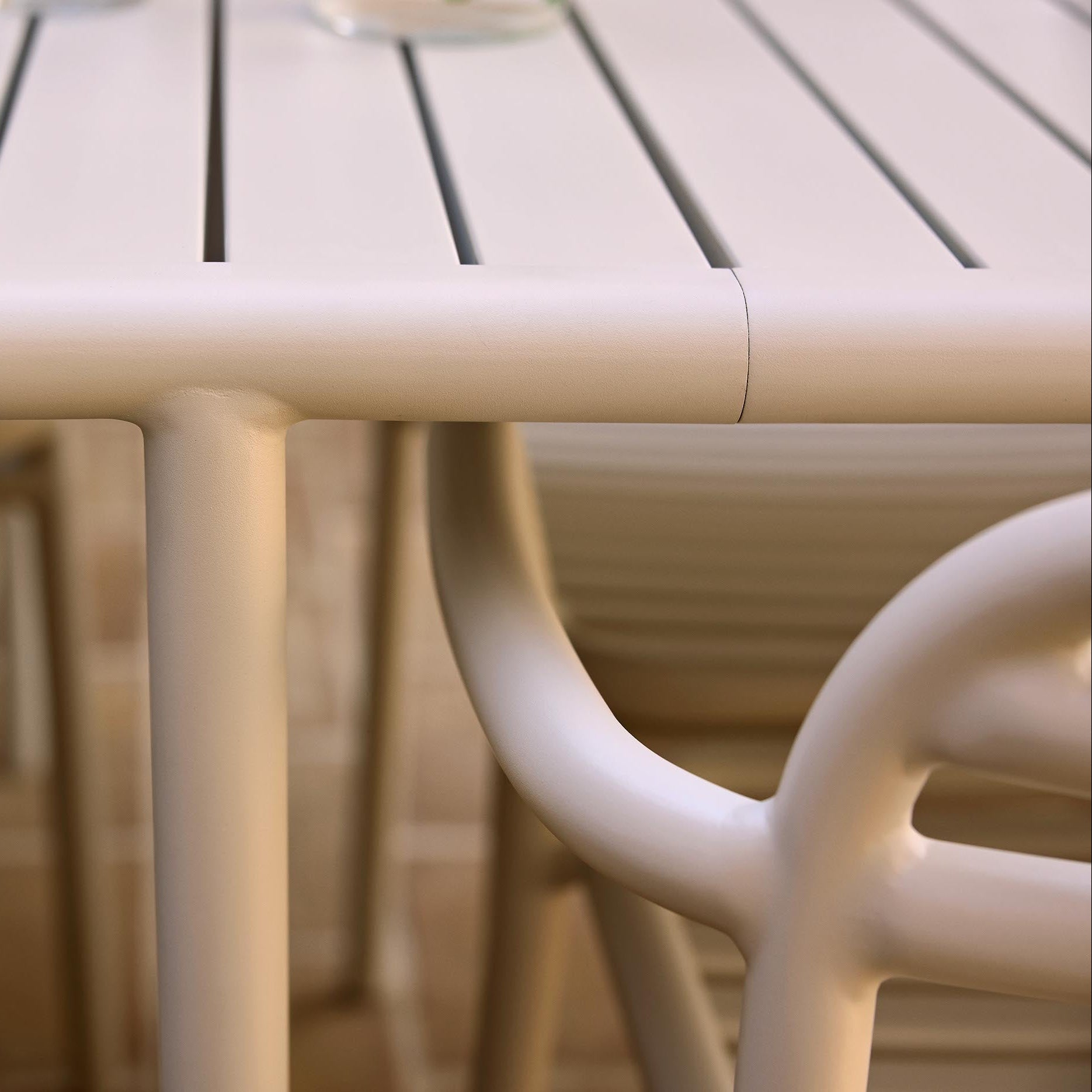 Beige outdoor table and chairs with a blurred background