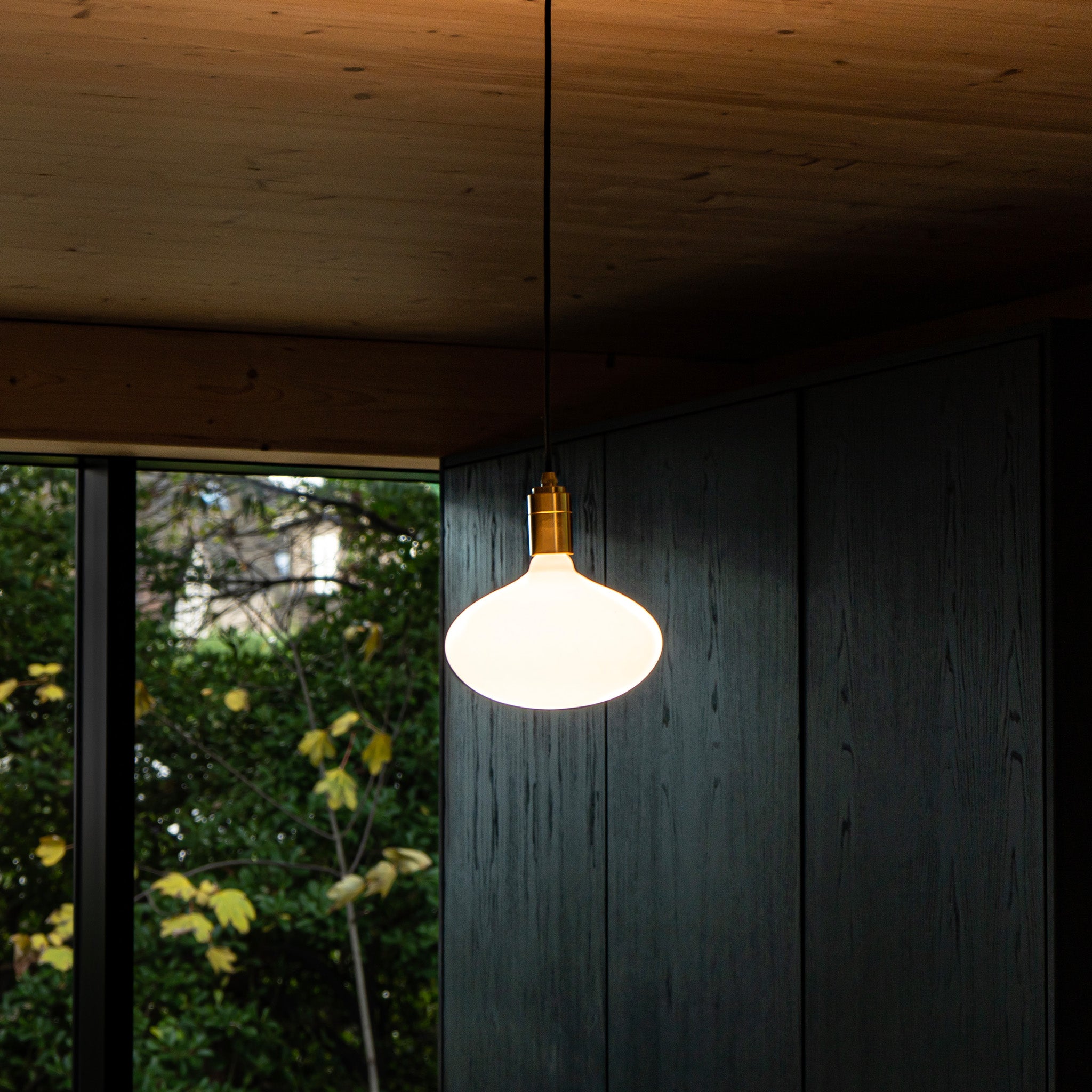 Oval II Plug-In Pendant by Tala — lifestyle setting, woven chair
