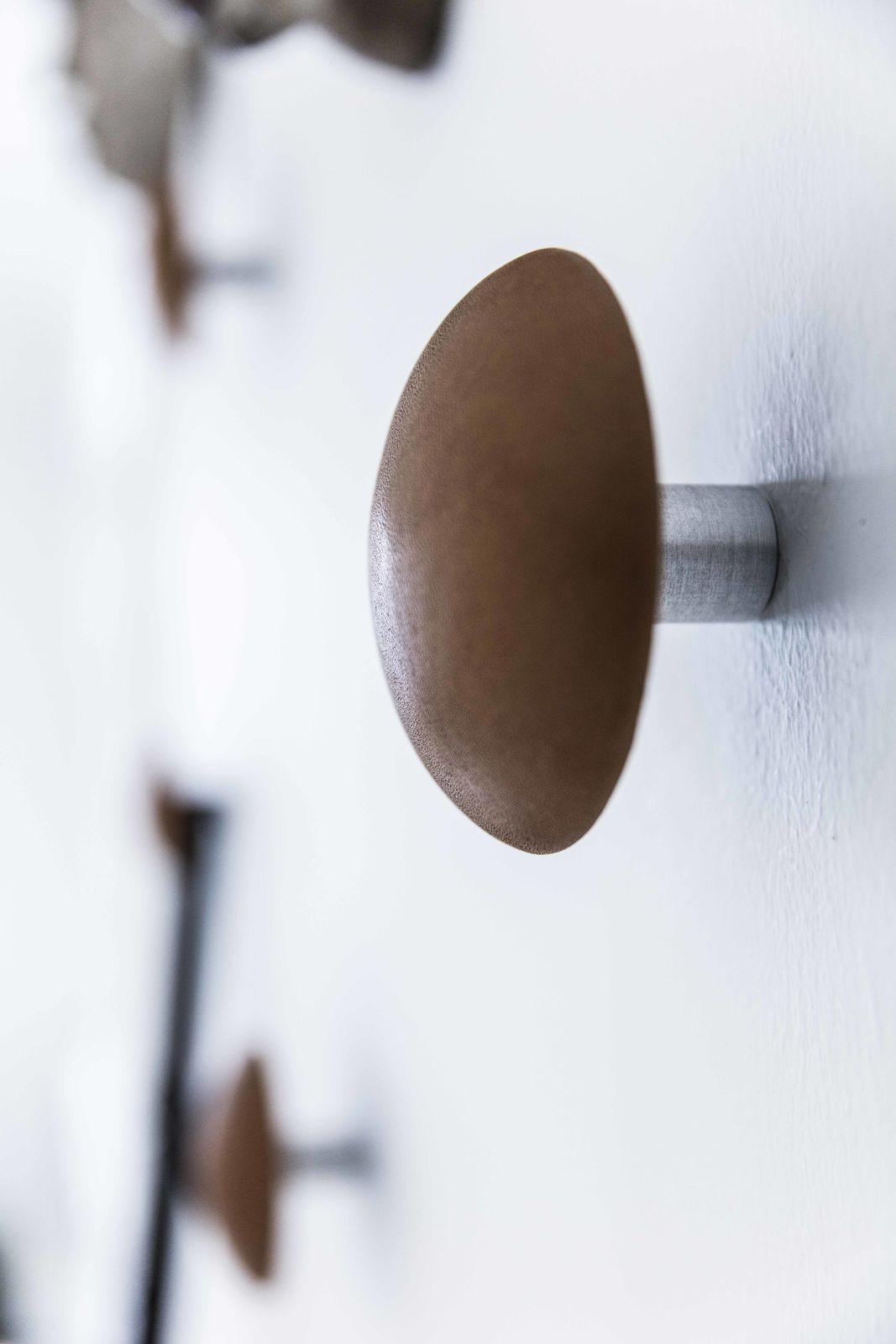 Detail of Bent Hansen Button-Up Wall Hook showing the aluminum wall spacer