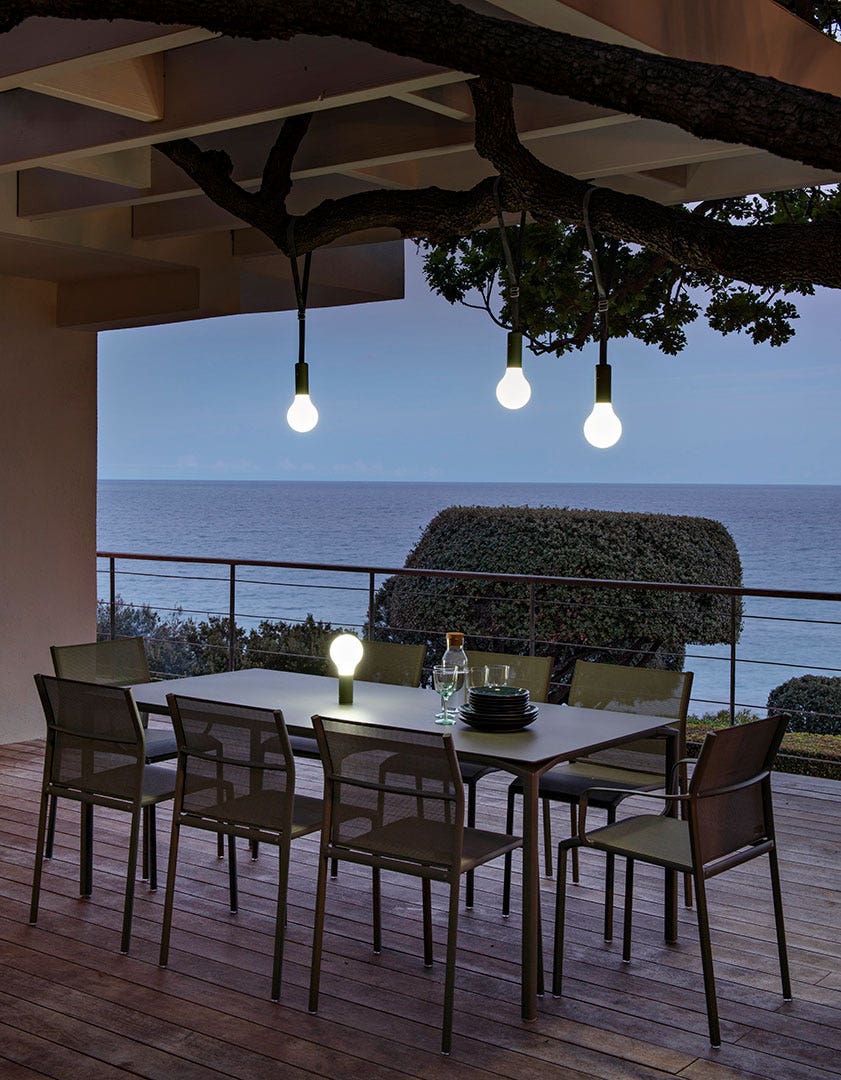 Fermob Cadiz 2-Seater Bench in Rosemary styled in a Mediterranean setting