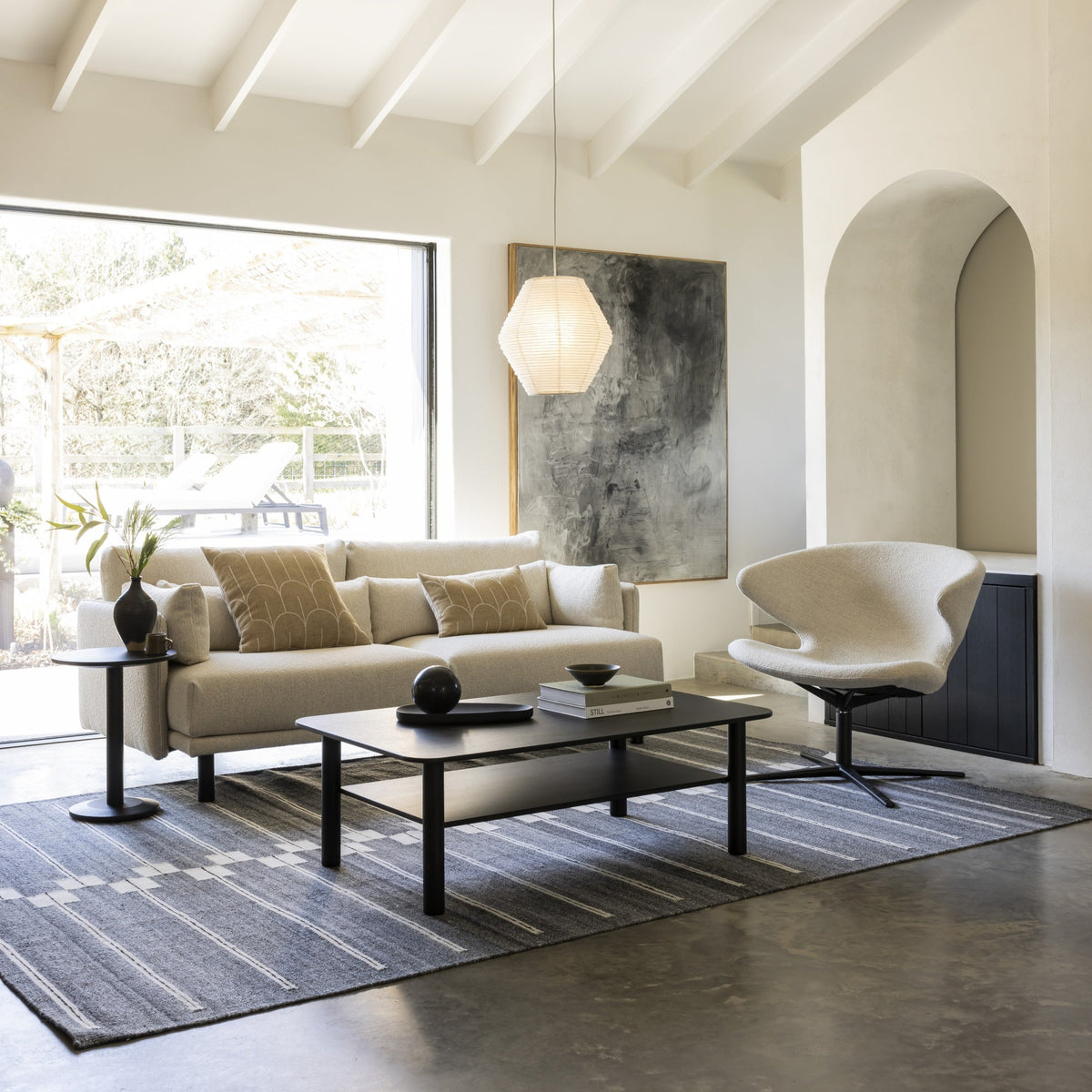 Case Spine RPET Rug in Warm Grey anchoring a seating group, styled in an interior setting, recycled PET