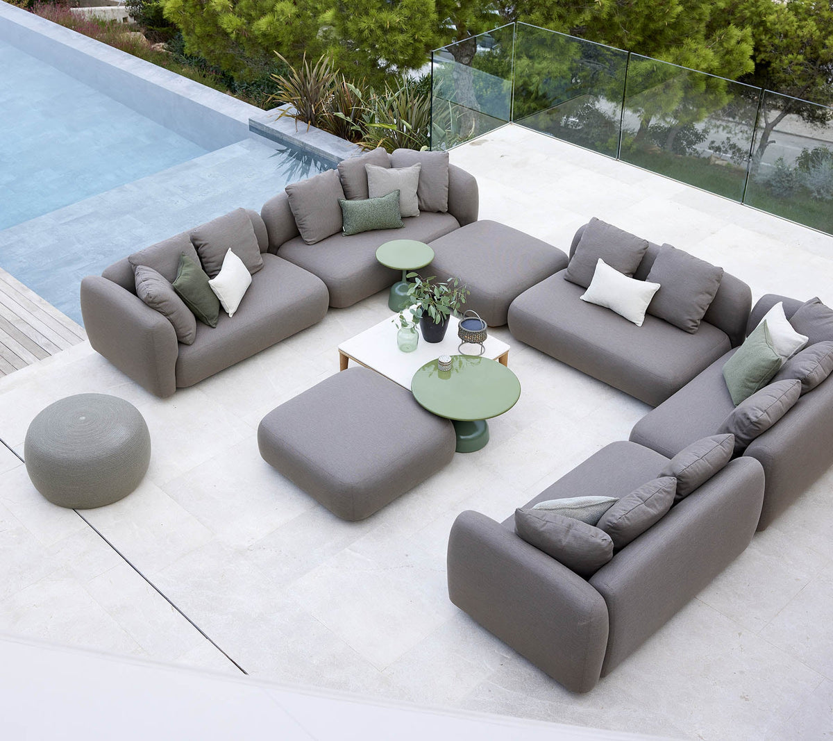 Cane-line Capture outdoor lounge in grey AirTouch acrylic beside a pool