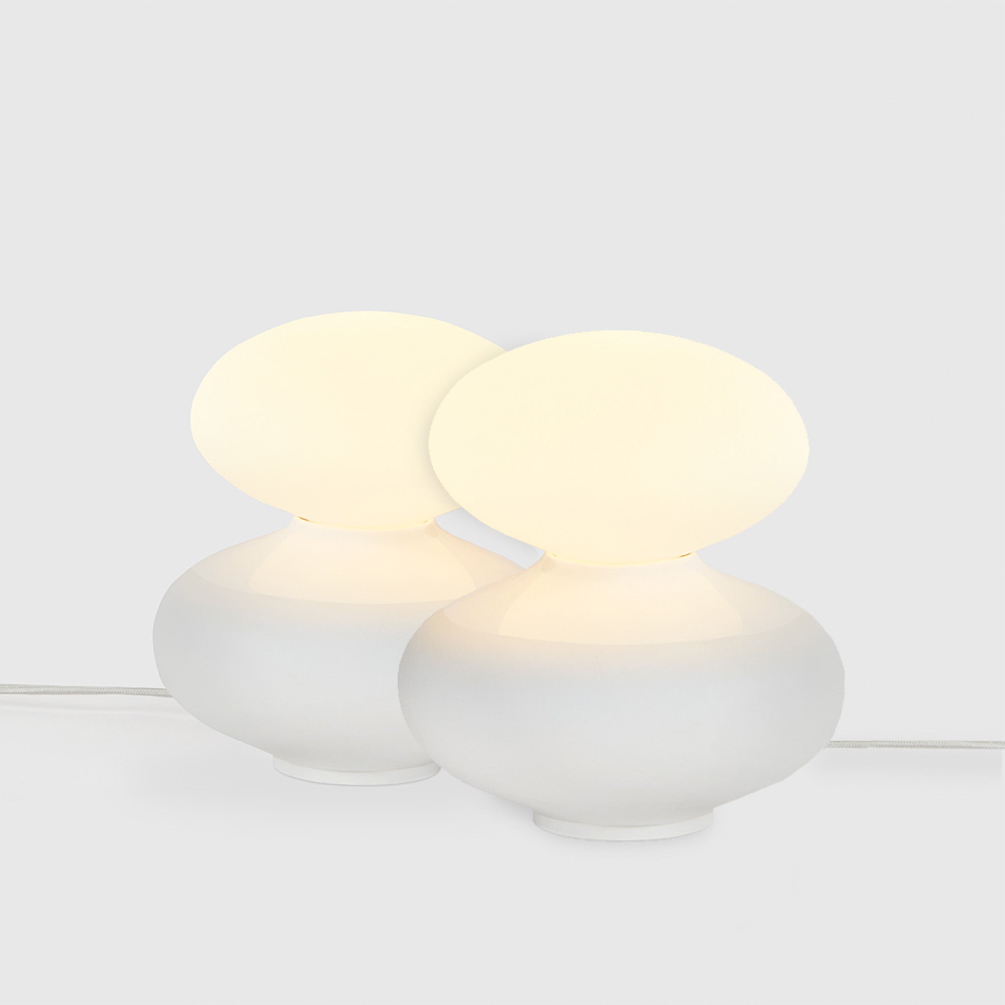 Tala Reflection Oval Table Lamps, Set of 2, lit, on grey background