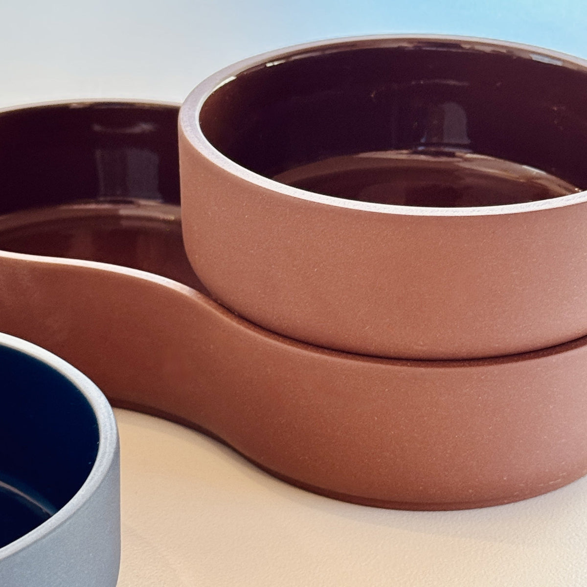 Detail of Case Dip Bowl showing the gloss-glazed interior and stacked Small and Large porcelain bowls