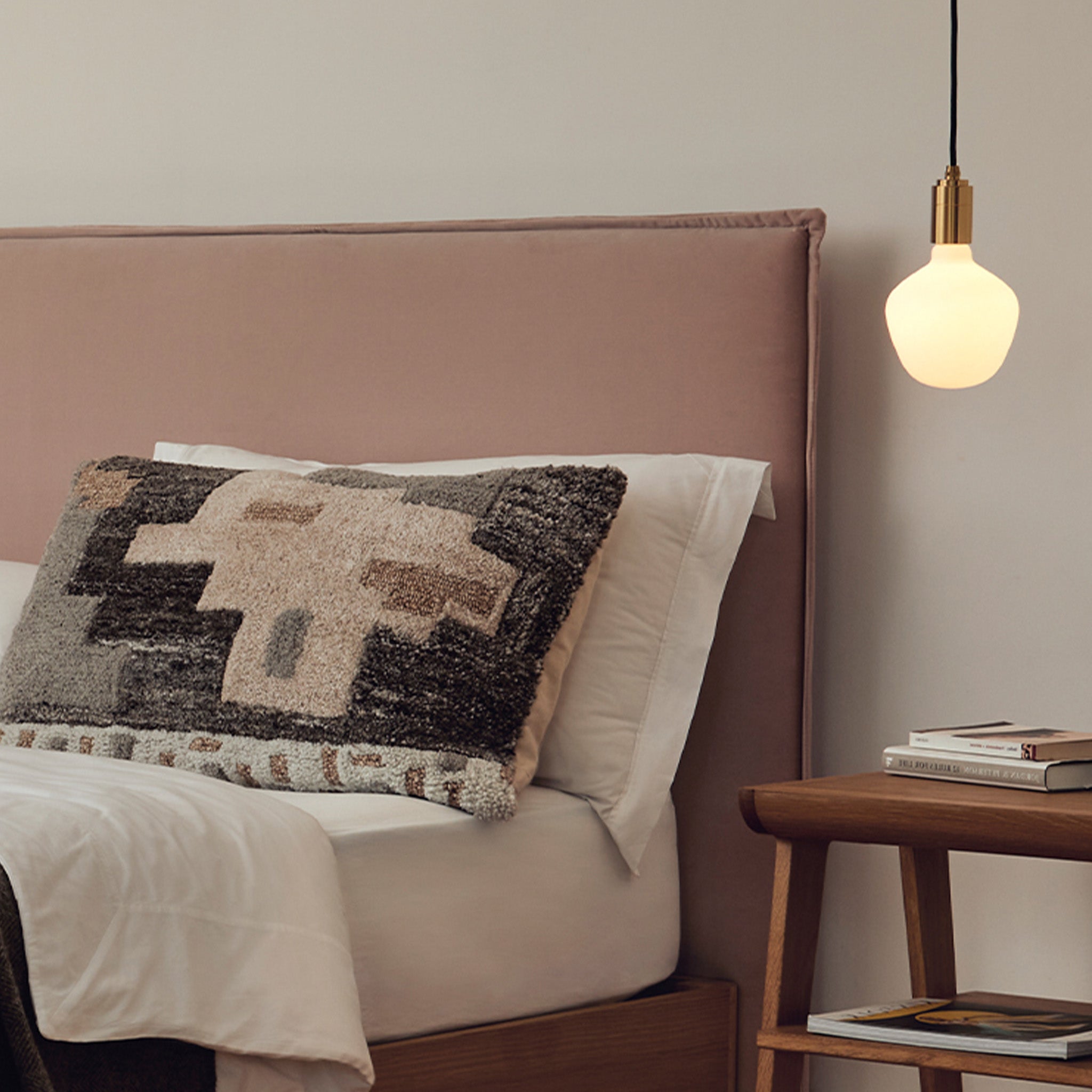 Enno Plug-In Pendant in Brass, shown in a bedroom setting