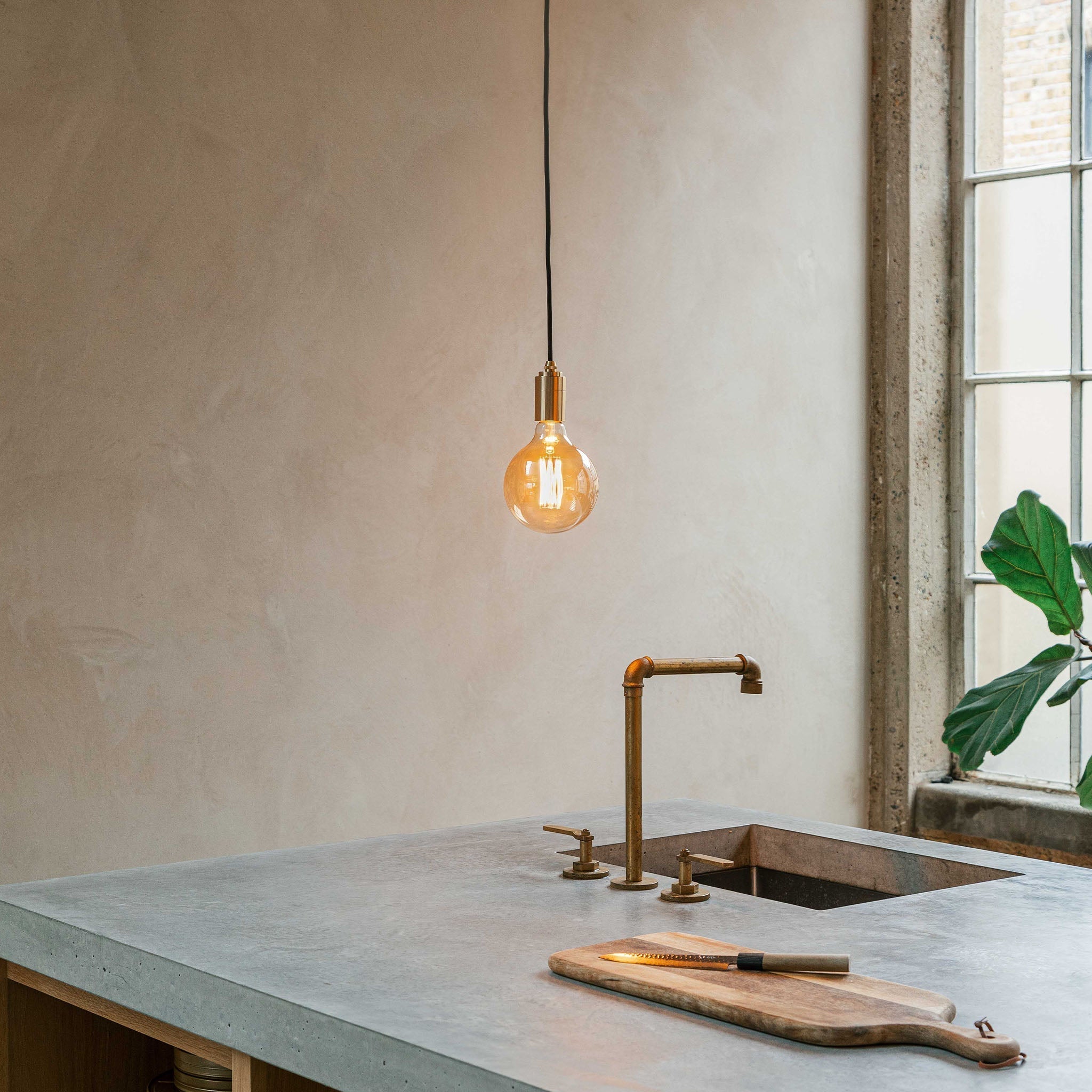 Gaia Pendant Light in Brass, shown in a kitchen setting