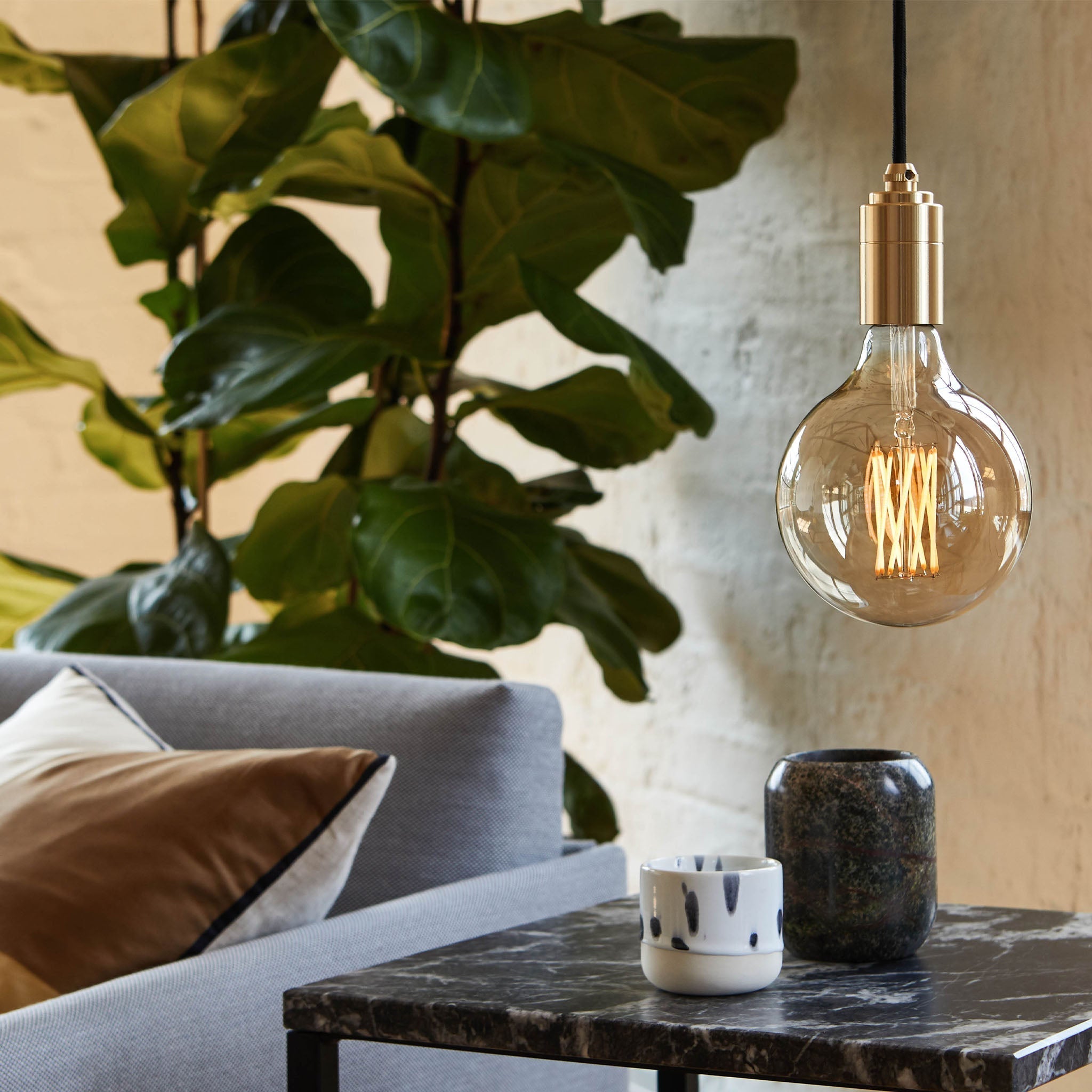 Side profile of the Gaia Pendant Light showing the iron-tinted glass bulb