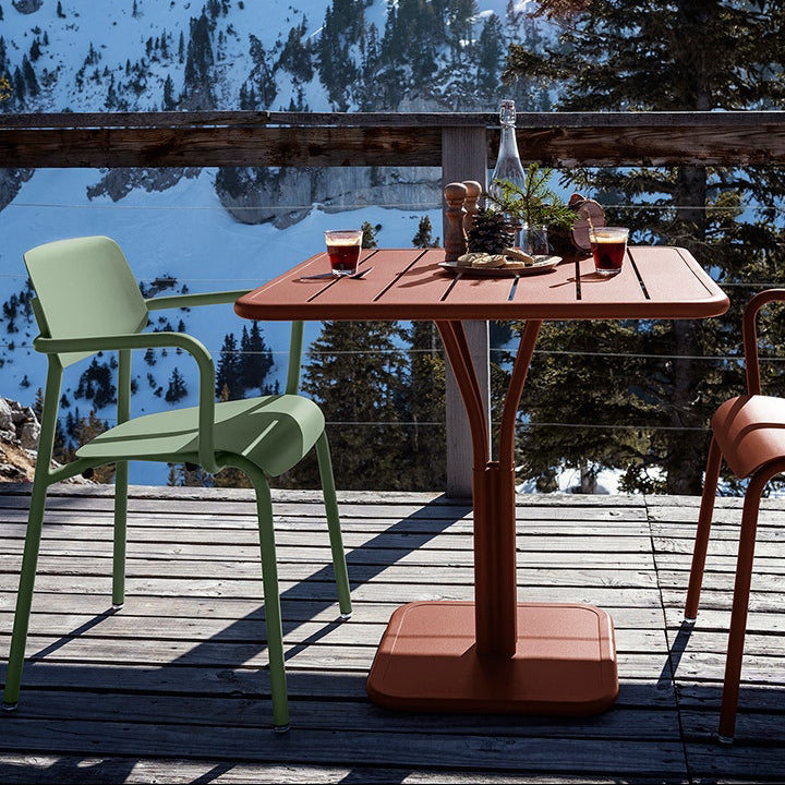Fermob Luxembourg Side Chair in Red Ochre styled in a mountain setting, the Luxembourg garden chair