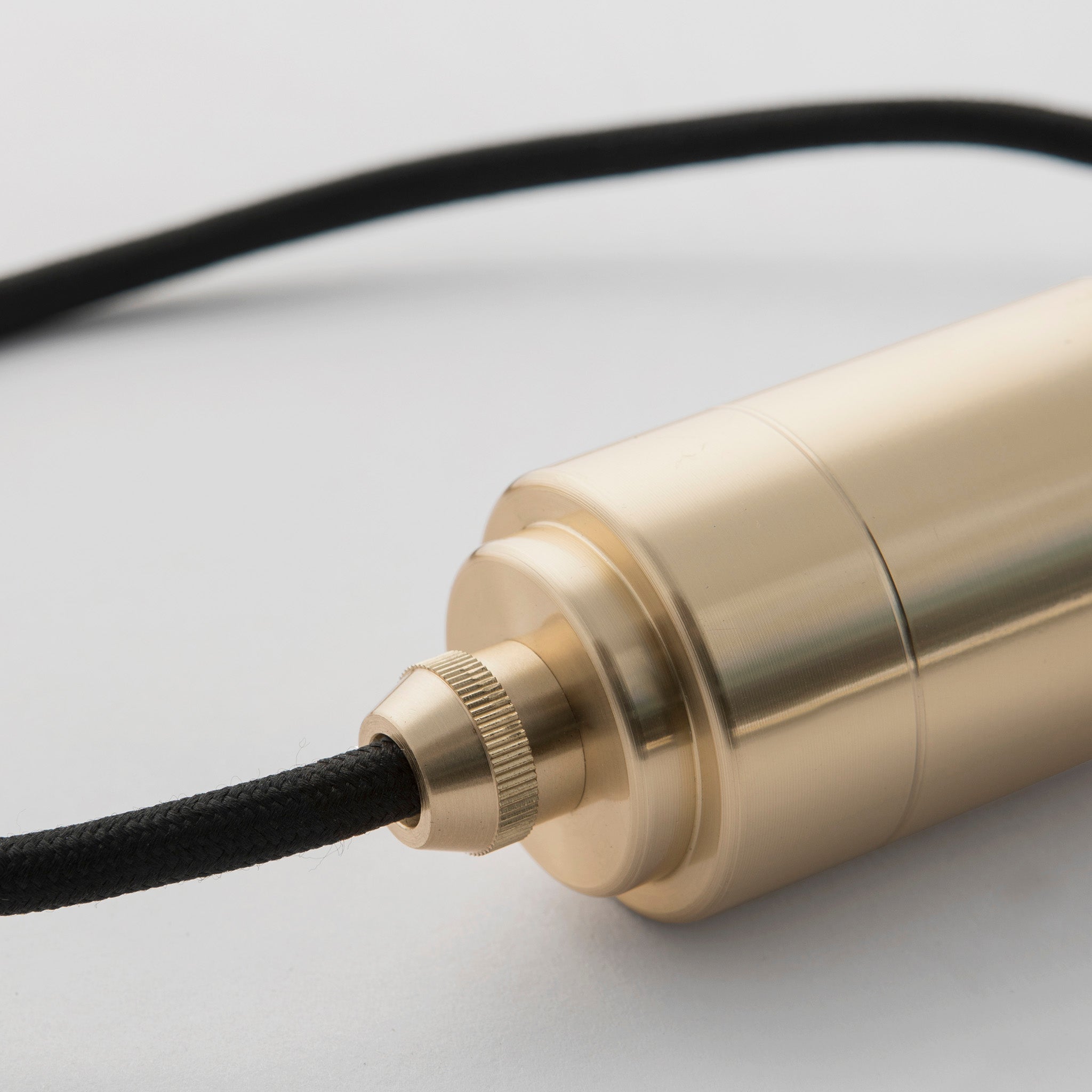 Tala Linear Triple Pendant in Brass, close-up detail shot of the brass canopy and cords