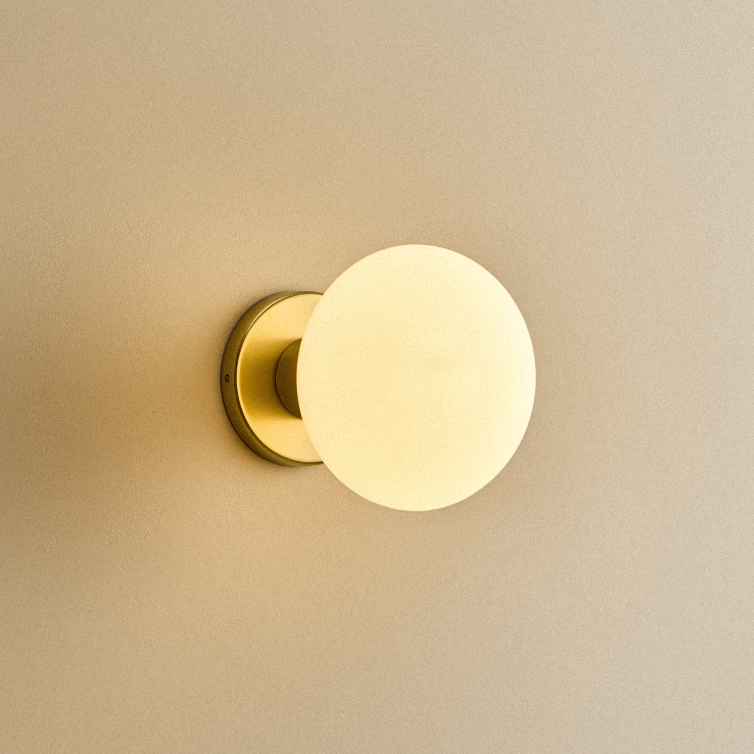 Lochan Wall Light in Brass with Oval bulb, illuminated