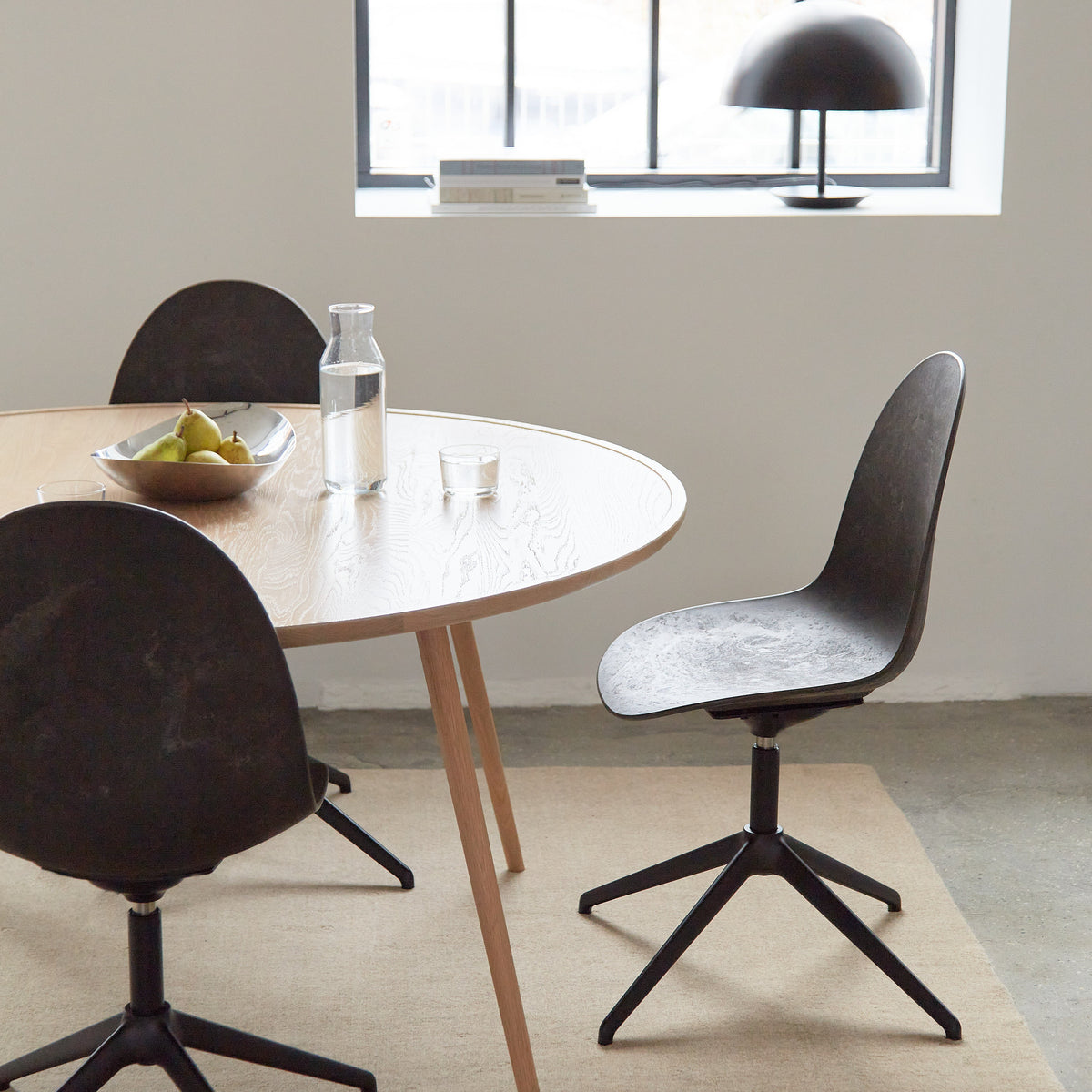 Mater Eternity Swivel Chair in Coffee Waste Black styled in an interior setting, Matek shell on a recycled aluminum base