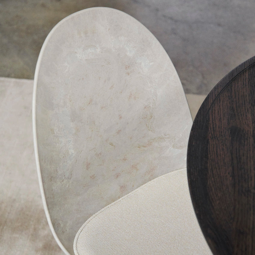 Detail of Mater Eternity Side Chair in Coffee Waste Light showing the molded edge of the recycled composite shell