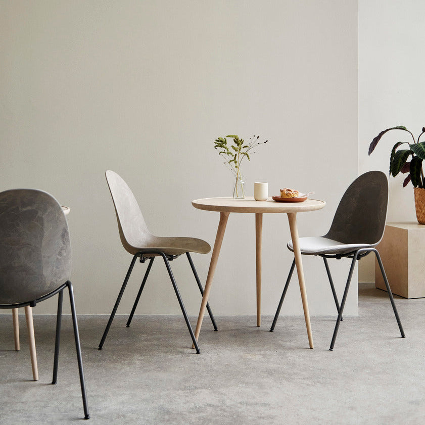 Mater Eternity Side Chair in Coffee Waste Dark styled in an interior setting, Matek shell on a recycled steel frame