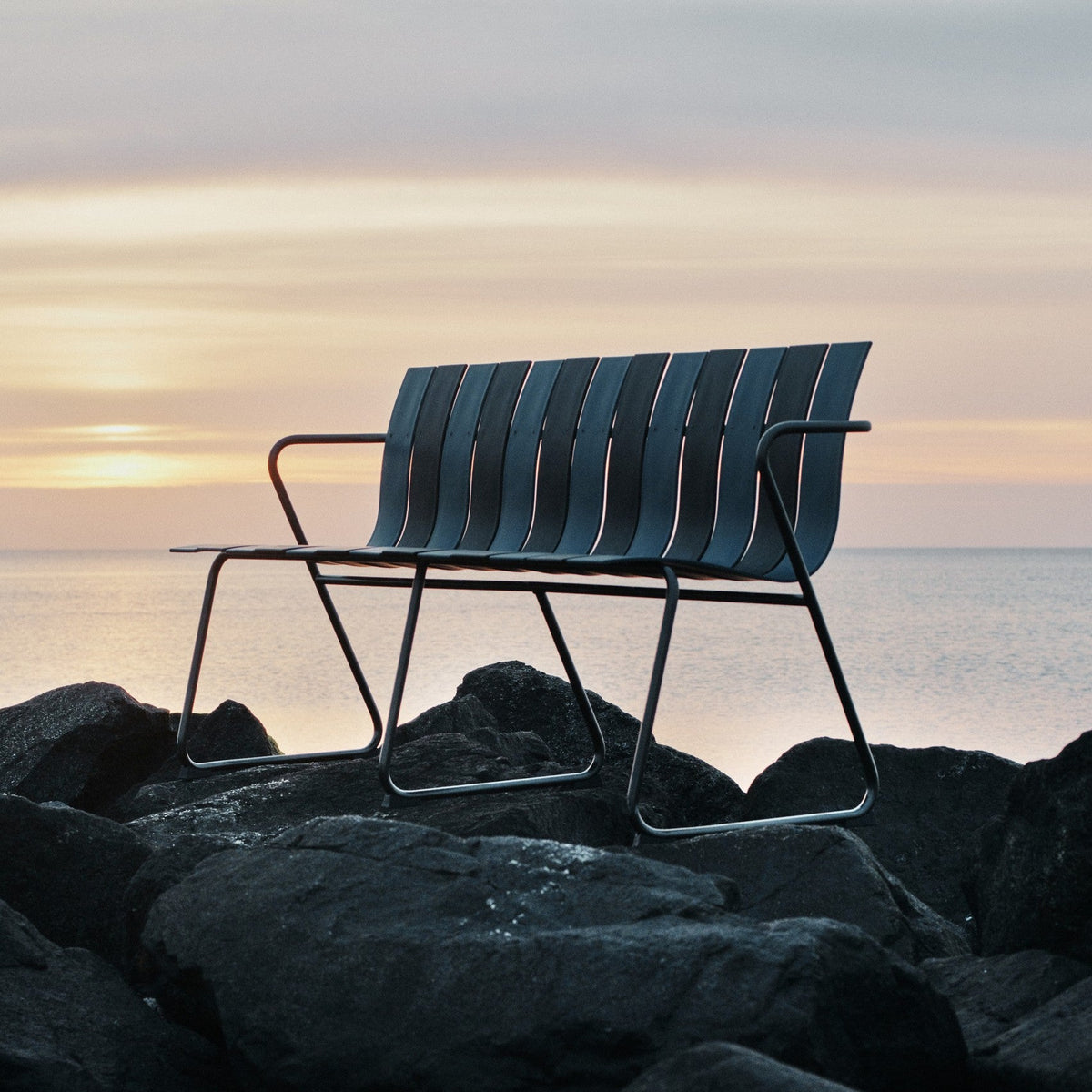 Mater Ocean Bench styled in an outdoor setting, slats of recycled plastic waste