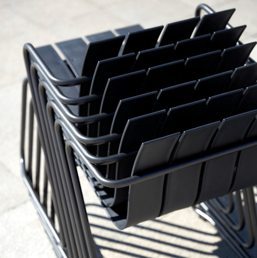 Mater Ocean Chairs stacked outdoors, slats of recycled ocean waste plastic