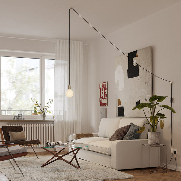 Tala Plug-In Pendant in Brass — lifestyle photo in a living space