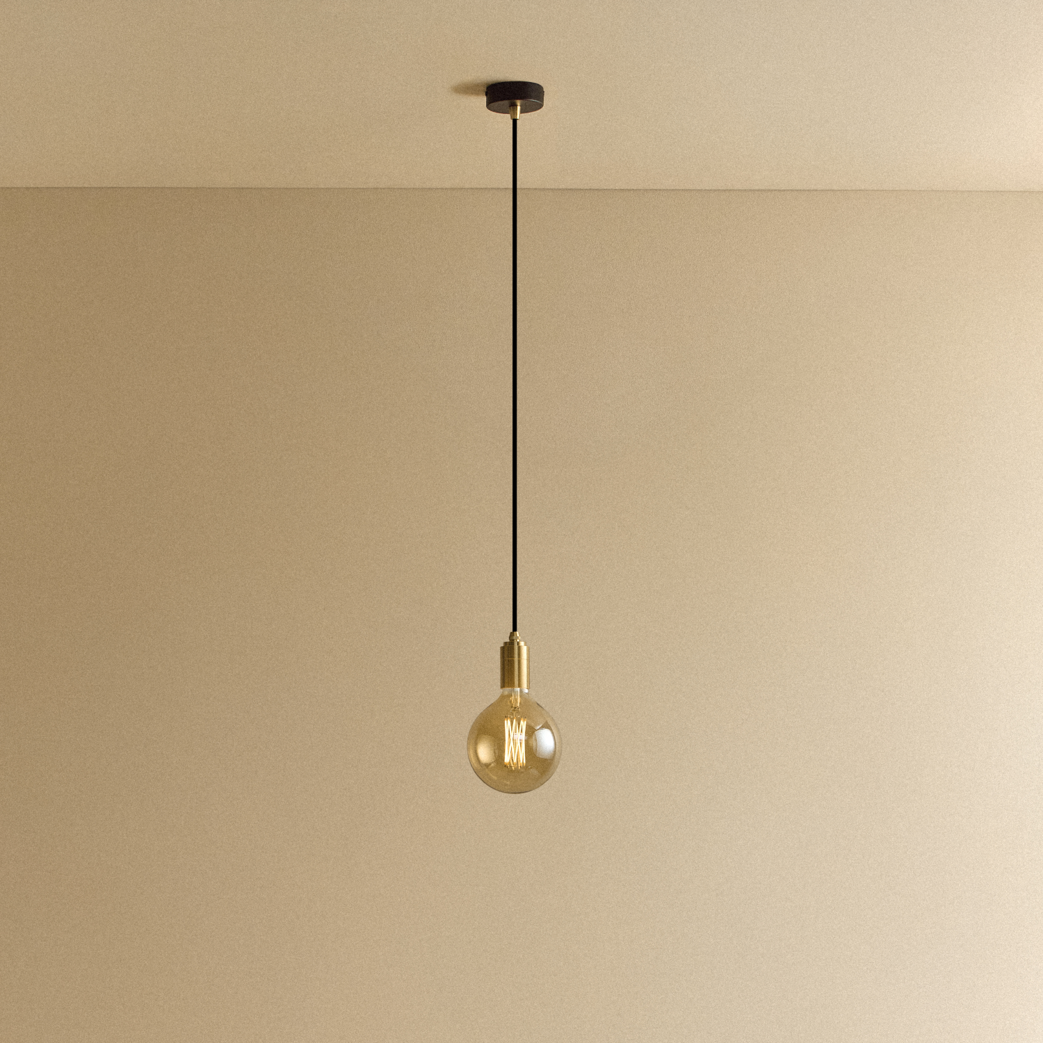 Gaia Pendant Light in Brass, front view of the amber-glow filament bulb