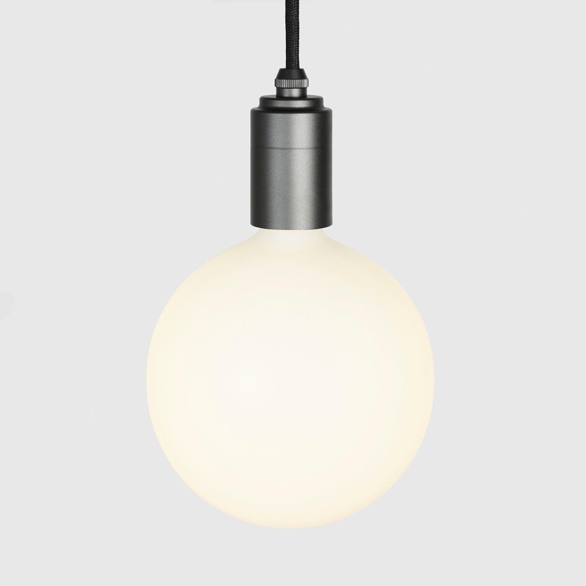 Sphere IV bulb in Graphite pendant, lit, grey background