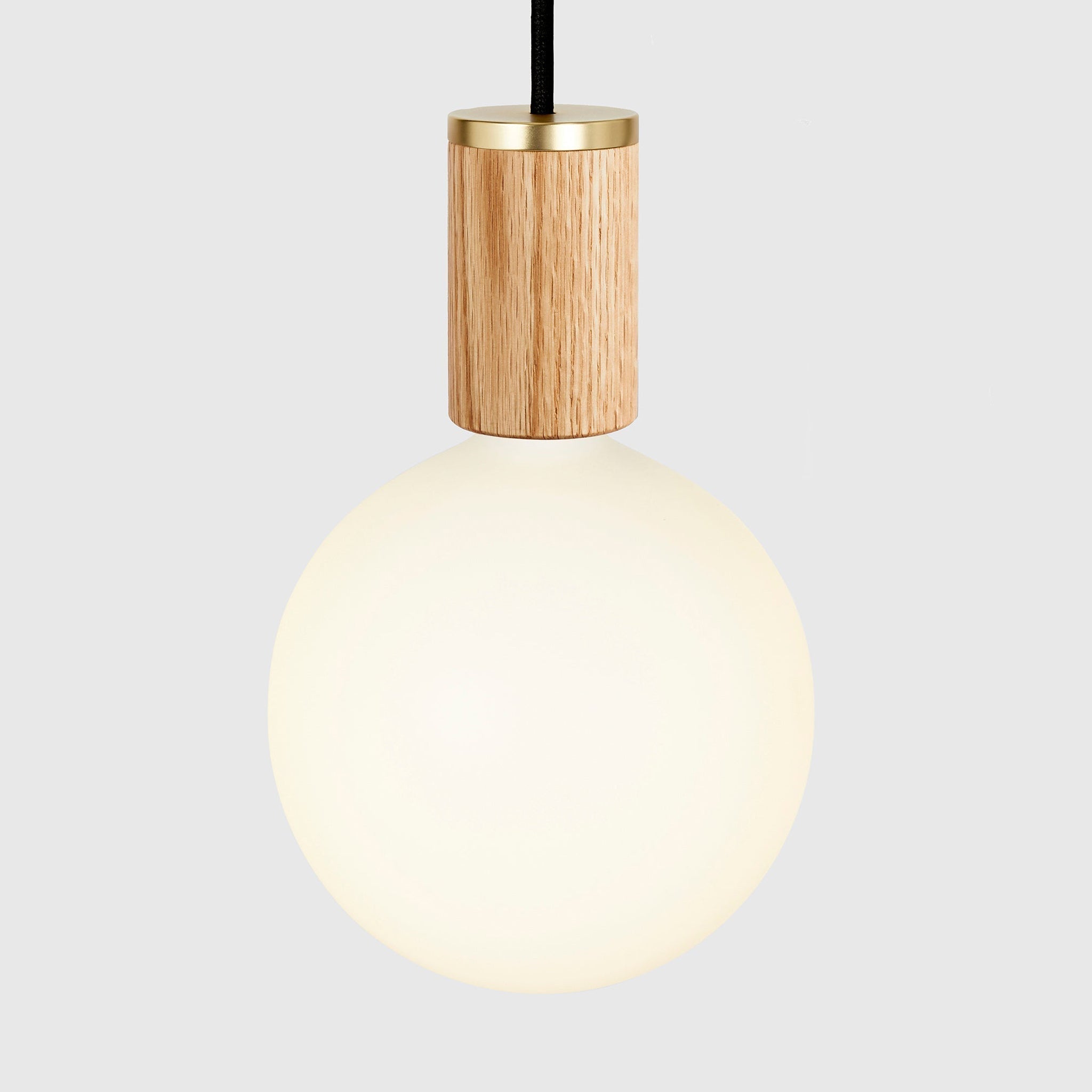 Sphere IV bulb in Oak pendant, lit, grey background