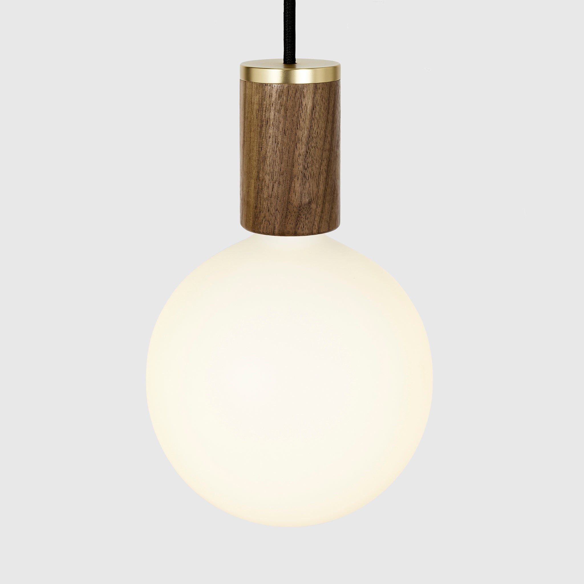 Sphere IV bulb in Walnut pendant, lit, grey background