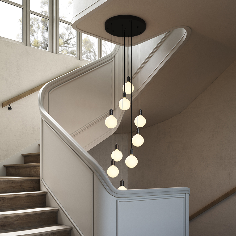 Tala Nine Pendant black canopy with Sphere IV bulbs, installed over a staircase (alt crop)