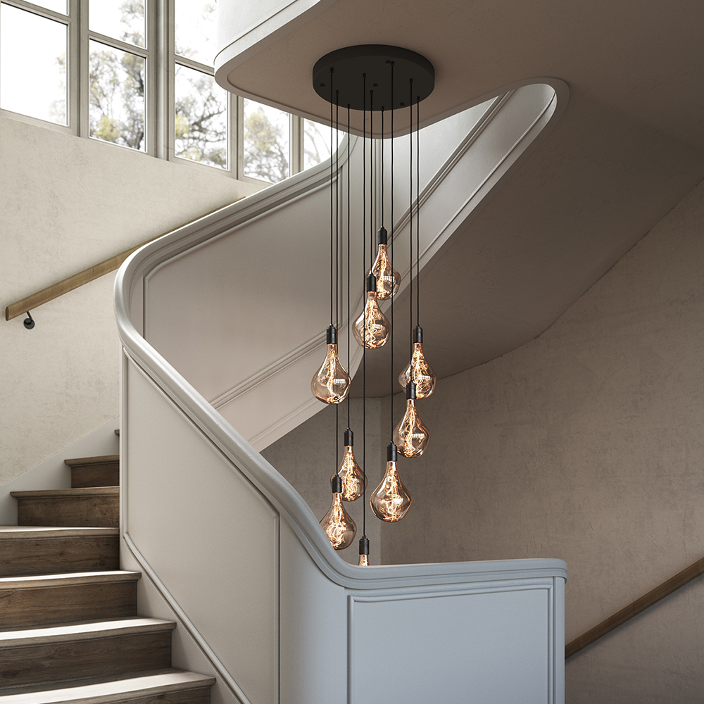 Tala Nine Pendant in Graphite with Voronoi II bulbs, installed over a staircase (alt crop)