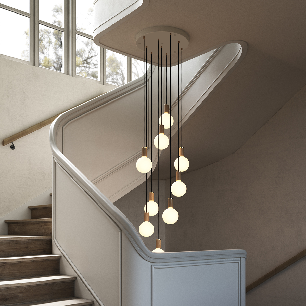 Tala Nine Pendant installed over a staircase, oak finish with Sphere IV bulbs